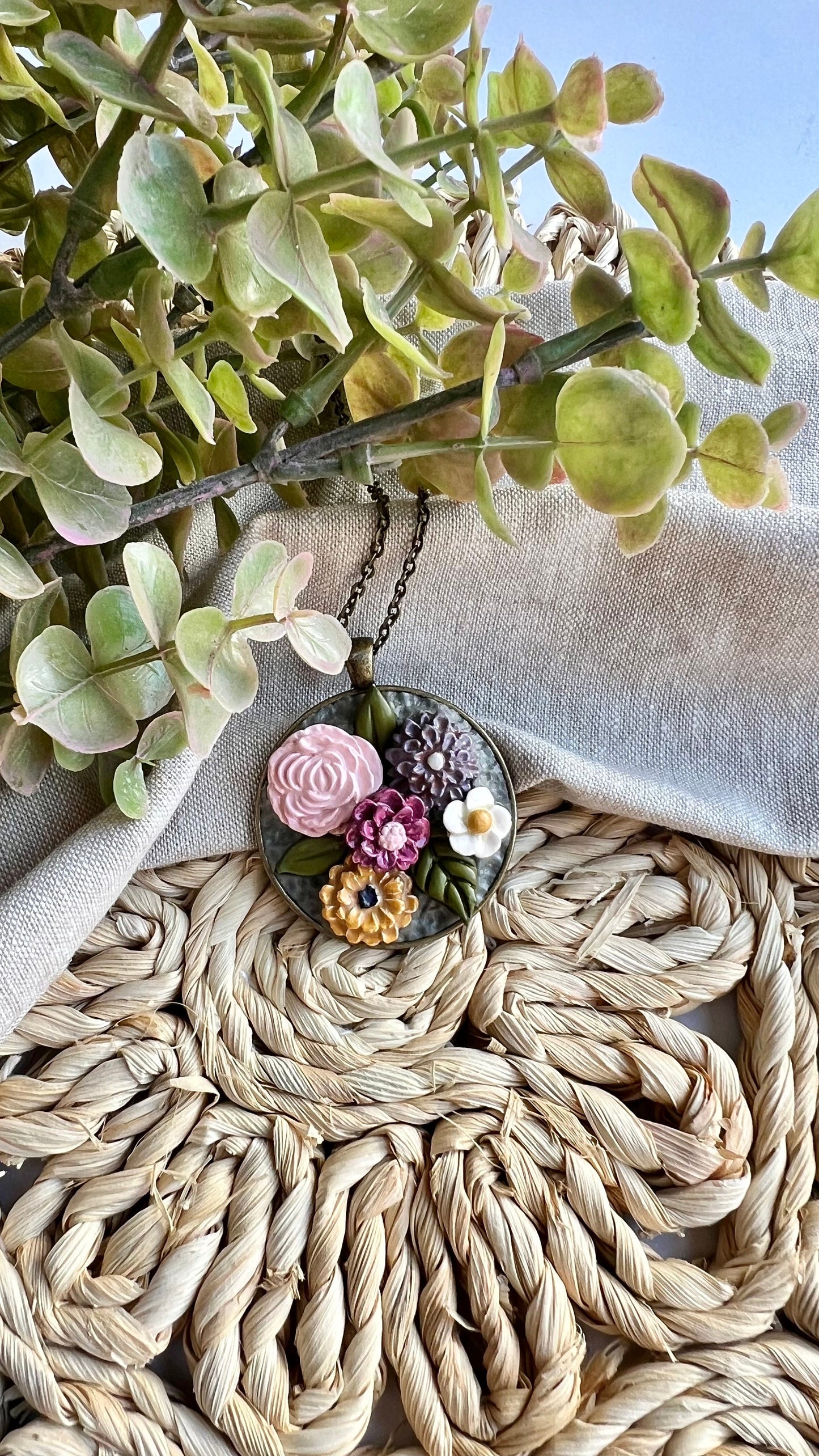 Polymer Clay pink yellow gray white floral pendant necklace in a round bronze bezel