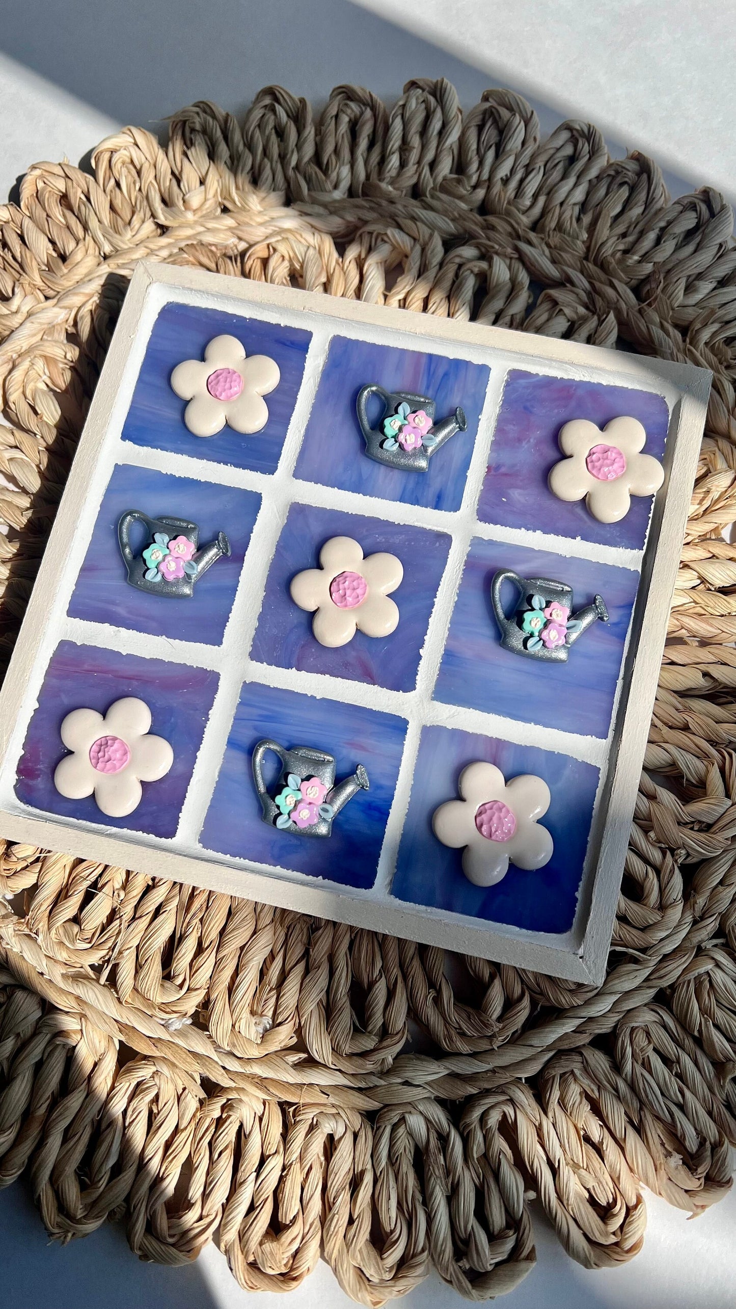Stained glass tic tac toe board with watering can and daisy playing pieces