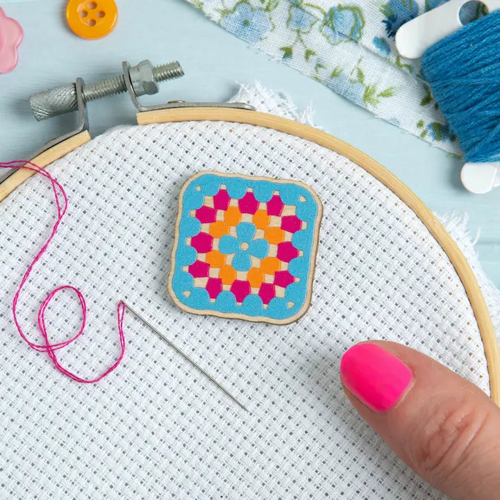 Wooden needle minder in the shape of a crochet granny square