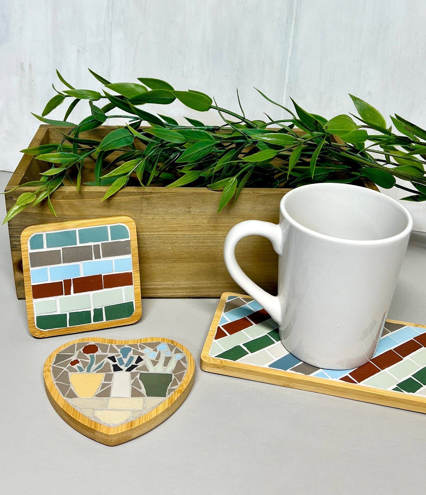 Heart shaped coaster with mosaic flowers in pots on a shelf