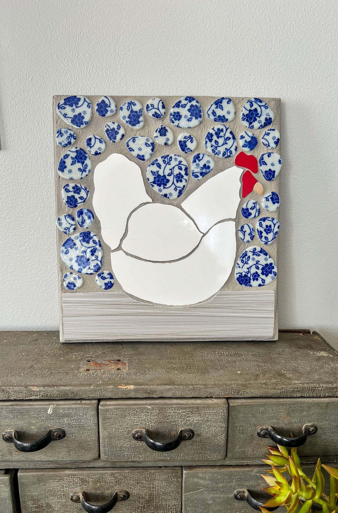 Mosaic white hen on a blue and white background