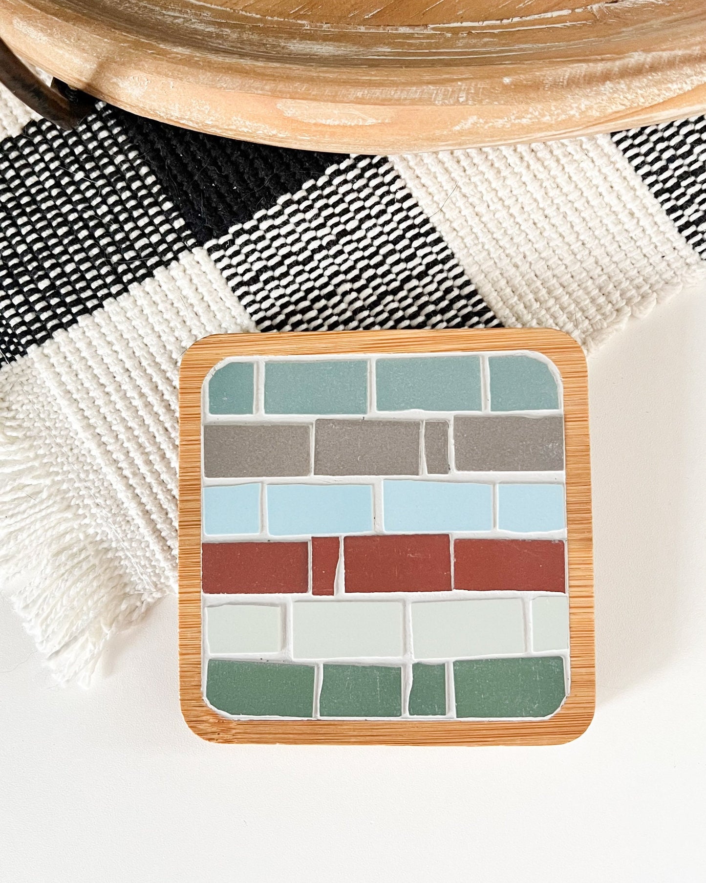 Mosaic square coaster in a wood base in blue brown red ivory and green