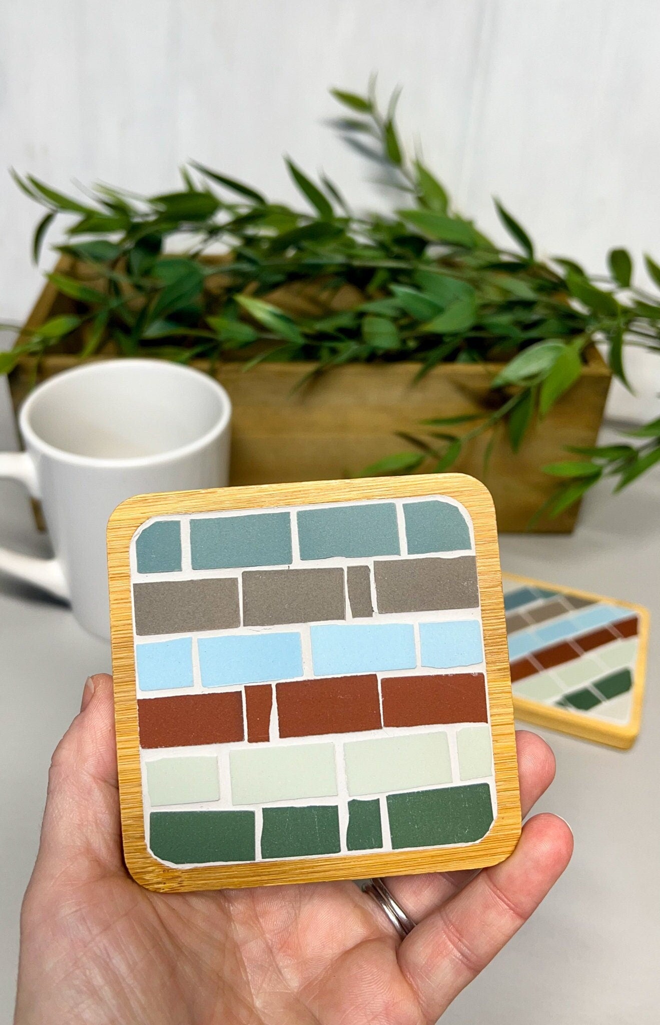 Mosaic square coaster in a wood base in blue brown red ivory and green