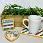 Striped rectangular mosaic coaster in deep red, blue, green, gray and ivory in a wood base with light gray grout