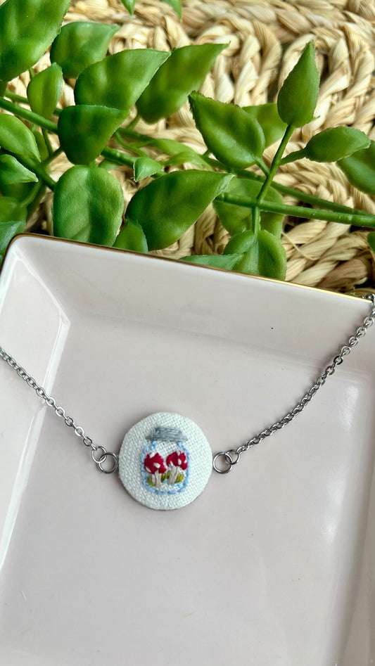 Embroidered mushroom in a jar set in a round bezel silver bracelet