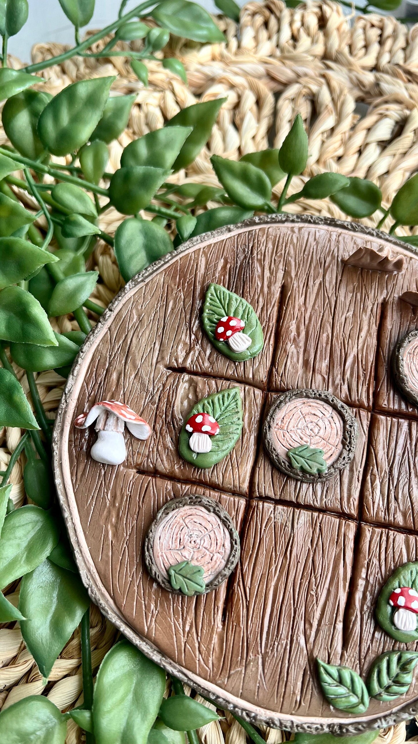 Polymer clay tic tac toe board with tree slice and mushroom pieces