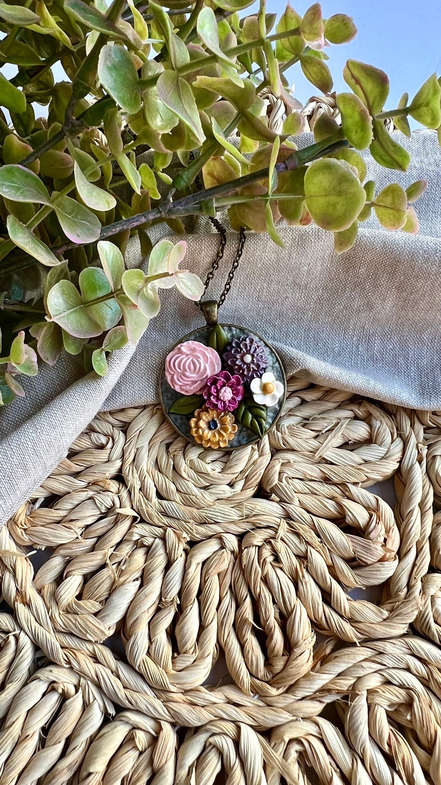 Polymer Clay pink yellow gray white floral pendant necklace in a round bronze bezel