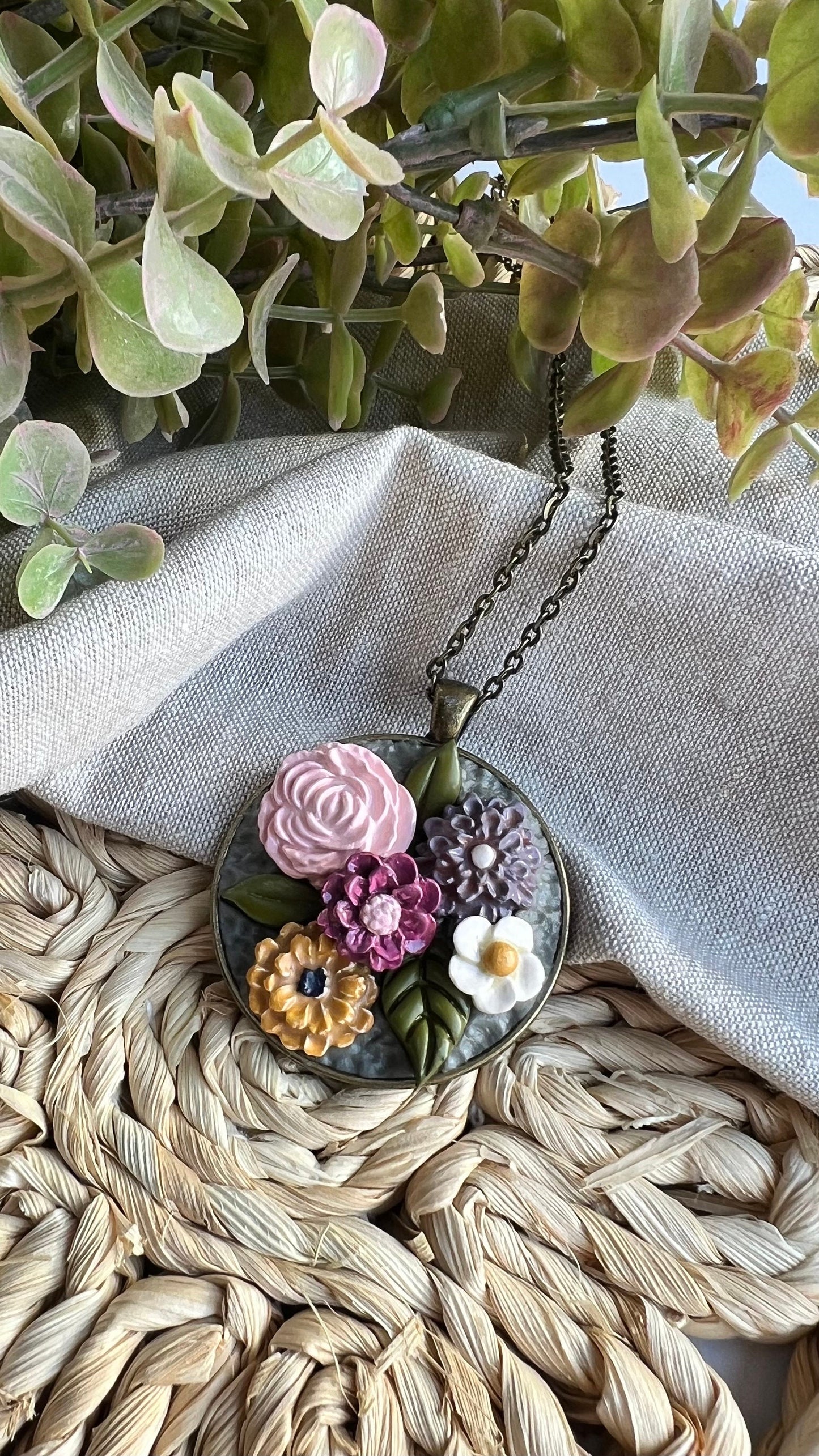 Polymer Clay pink yellow gray white floral pendant necklace in a round bronze bezel