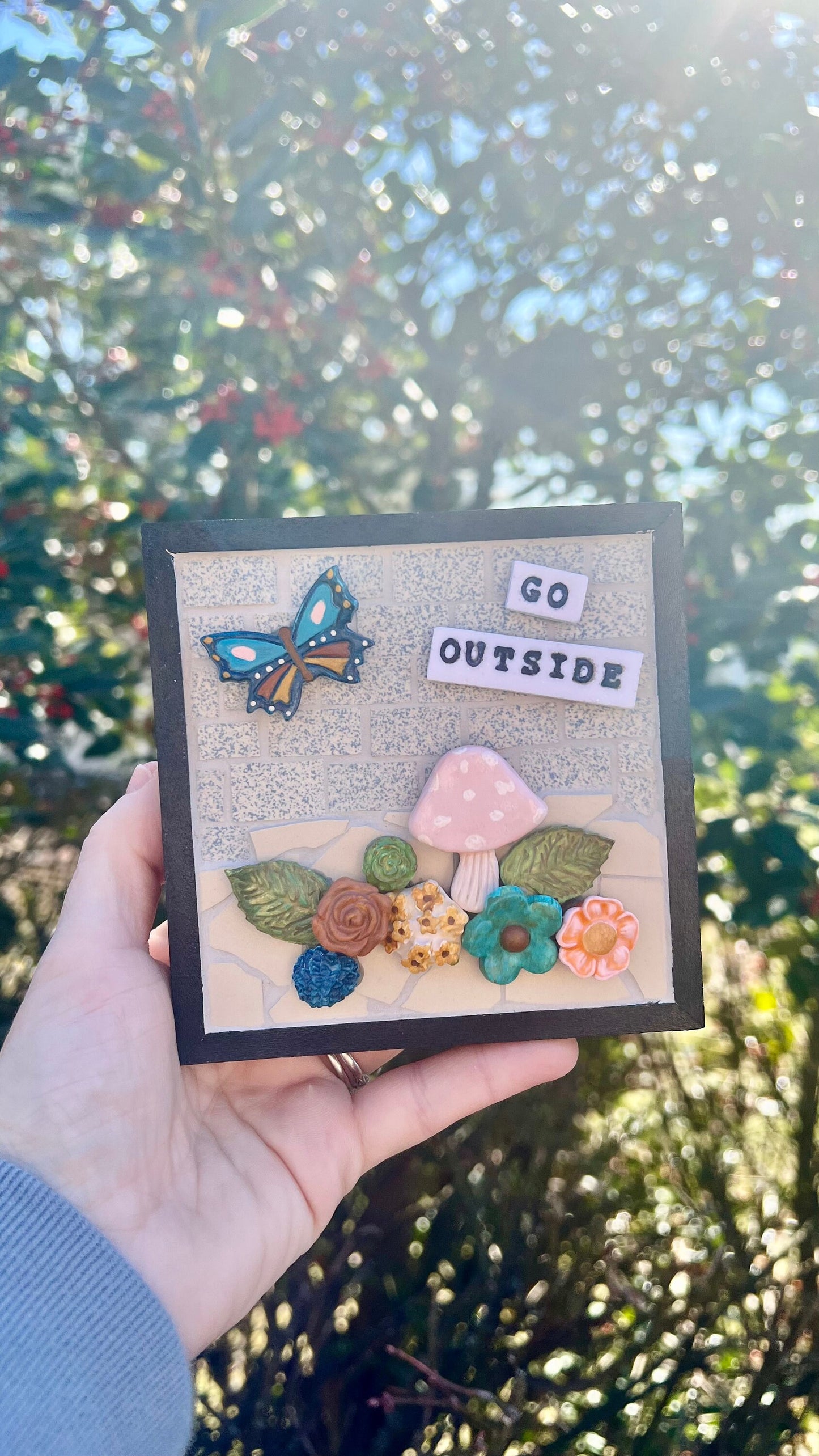 Mixed media clay and mosaic wall art with butterfly mushroom and flowers