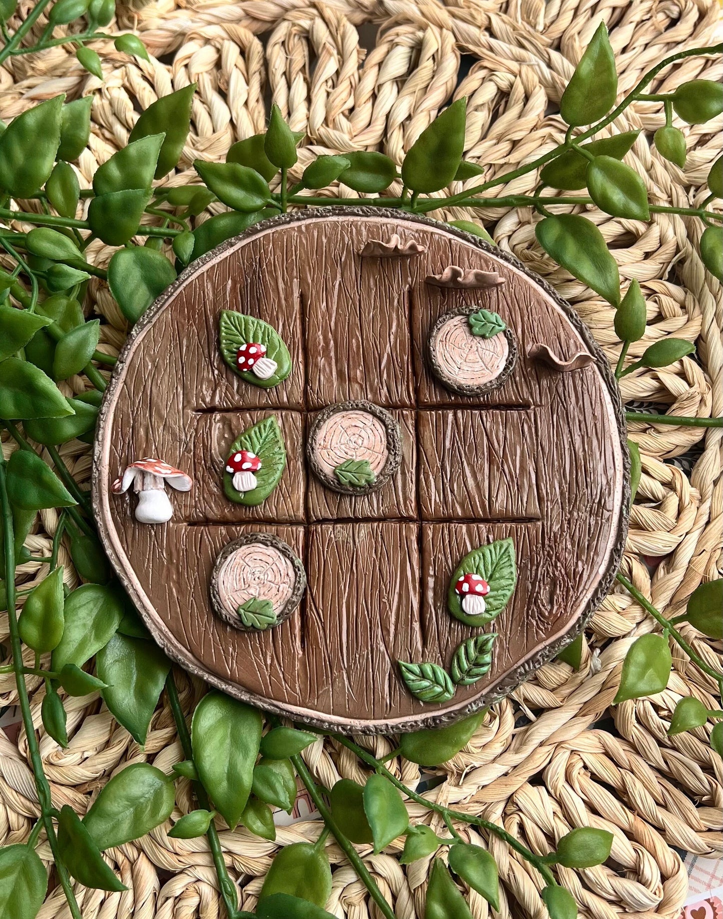 Polymer clay tic tac toe board with tree slice and mushroom pieces