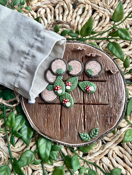 Polymer clay tic tac toe board with tree slice and mushroom pieces