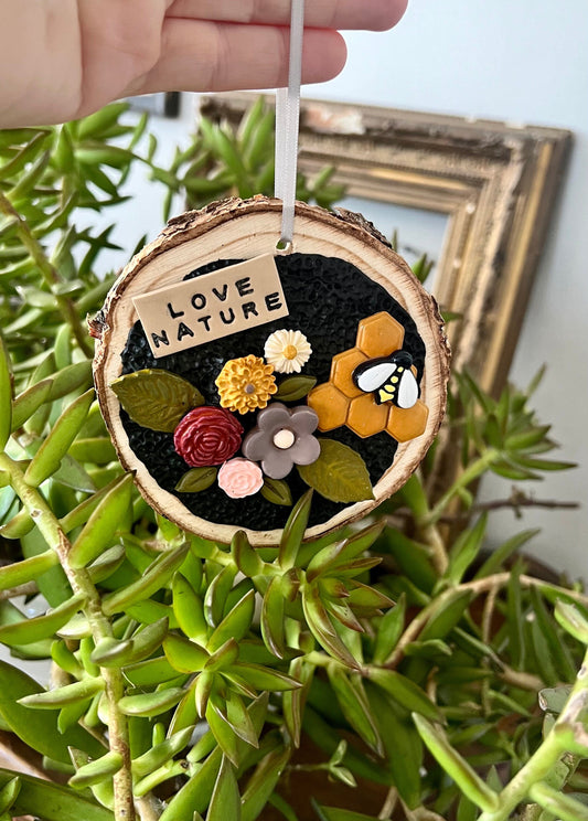 Tree slice ornament with clay flowers and honeycomb