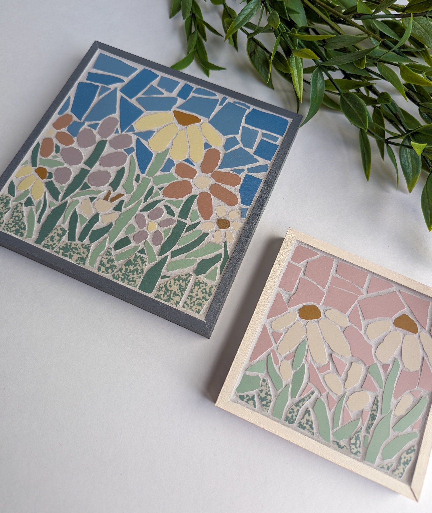 Floral mosaic set in a gray wooden frame featuring spring flowers in lavender, pink, yellow and off white