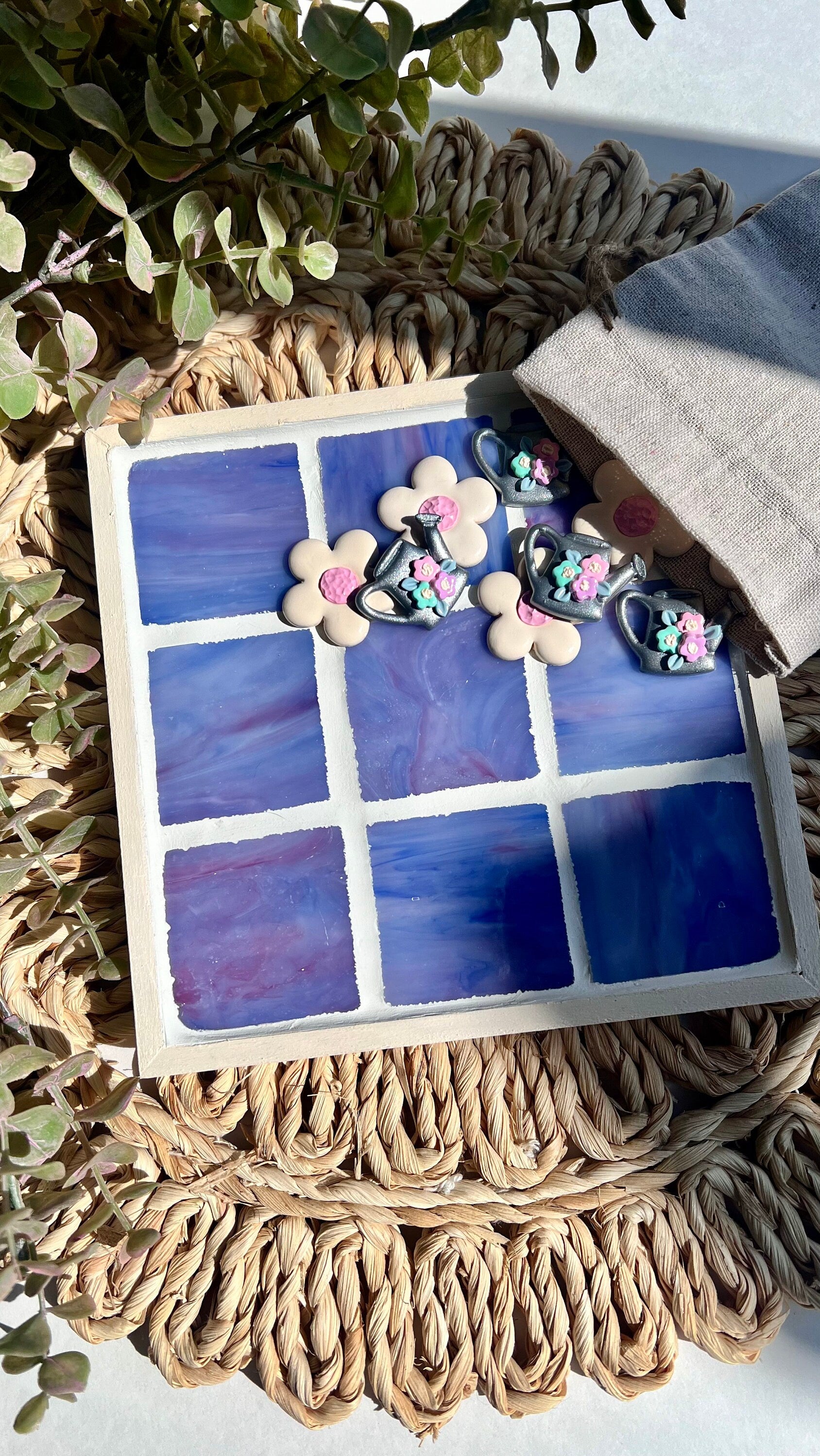 Stained glass tic tac toe board with watering can and daisy playing pieces