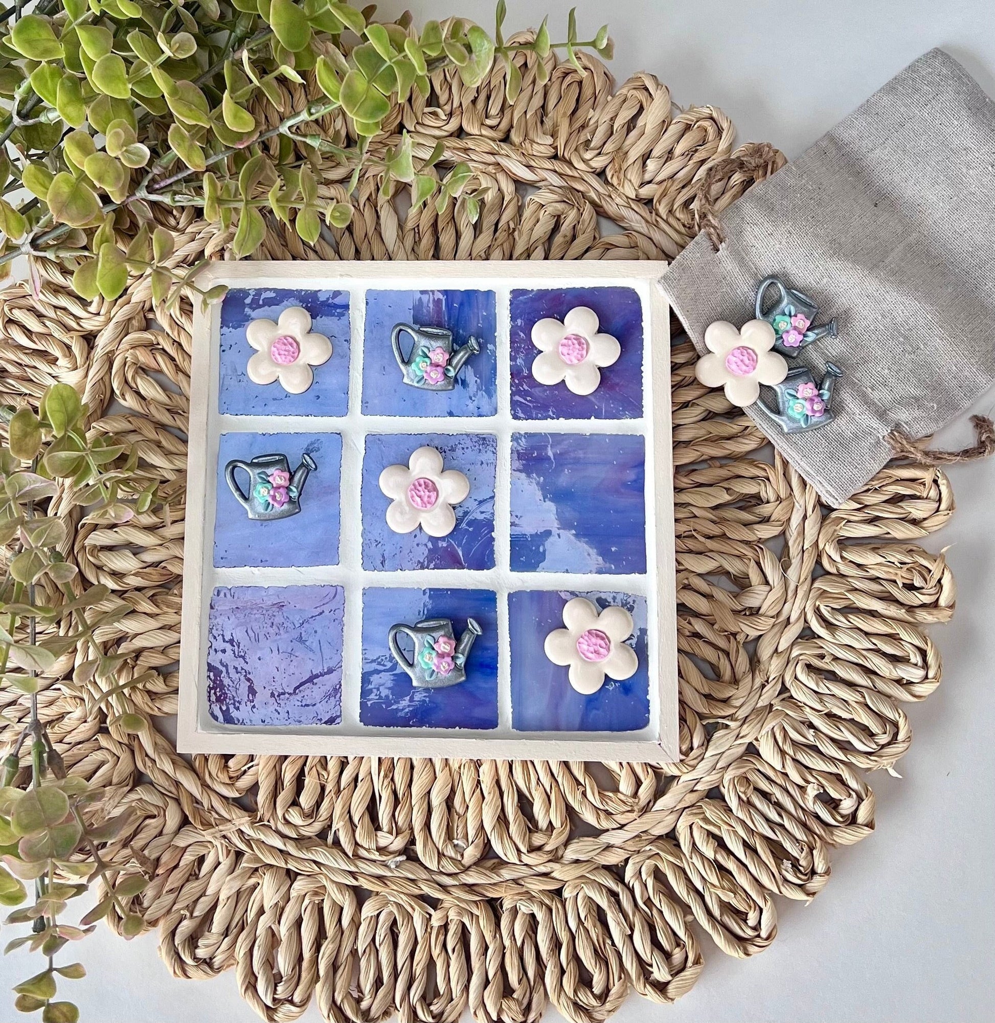 Stained glass tic tac toe board with watering can and daisy playing pieces