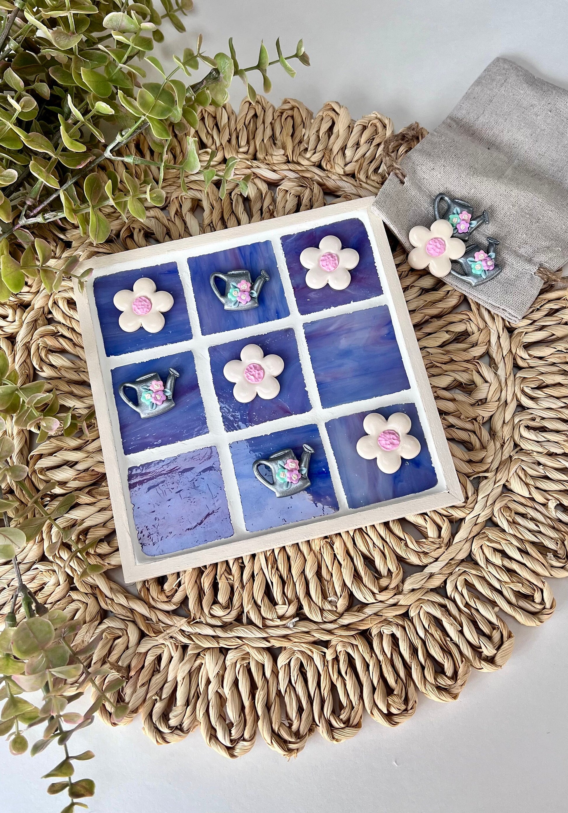 Stained glass tic tac toe board with watering can and daisy playing pieces