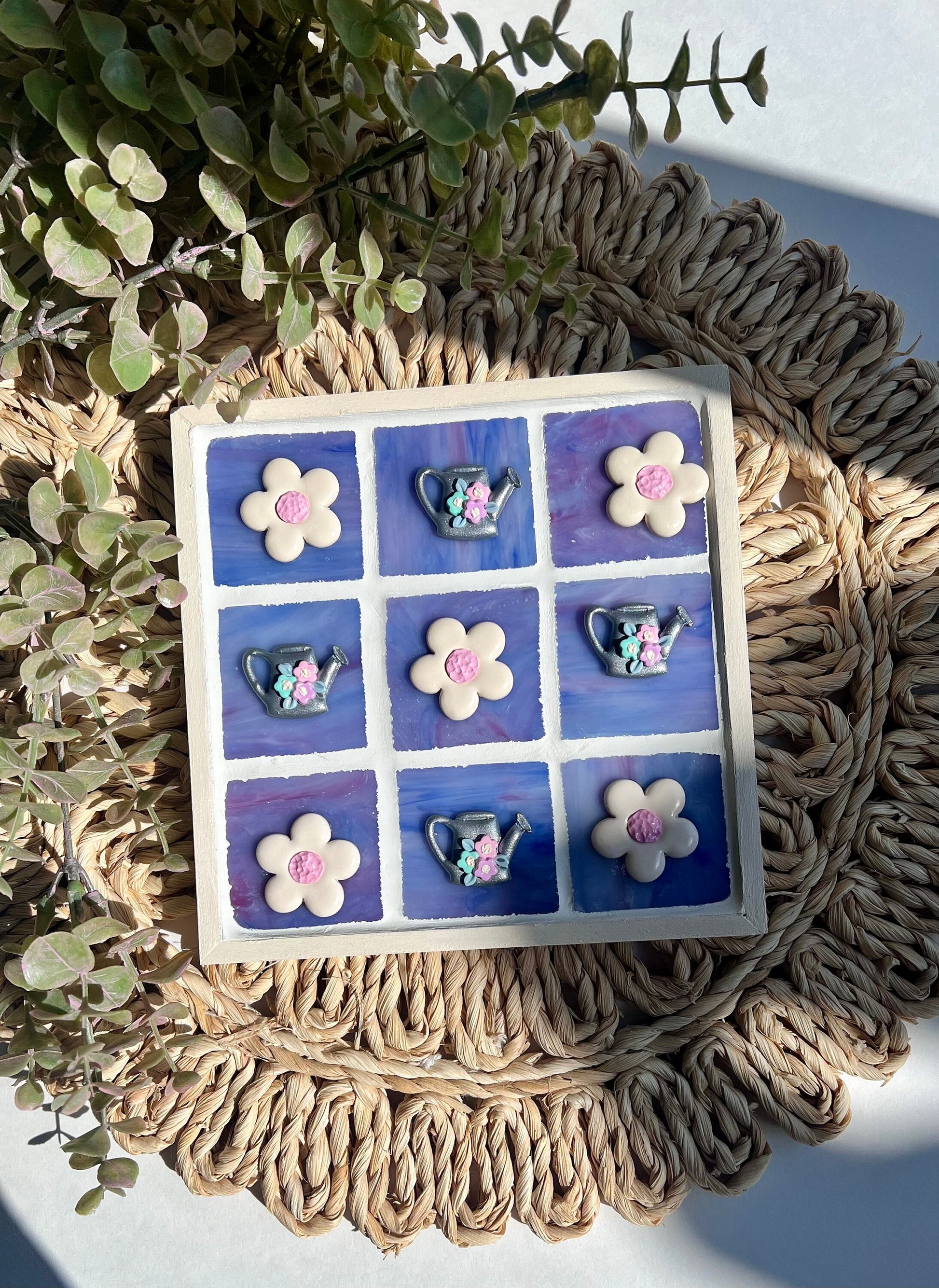 Stained glass tic tac toe board with watering can and daisy playing pieces