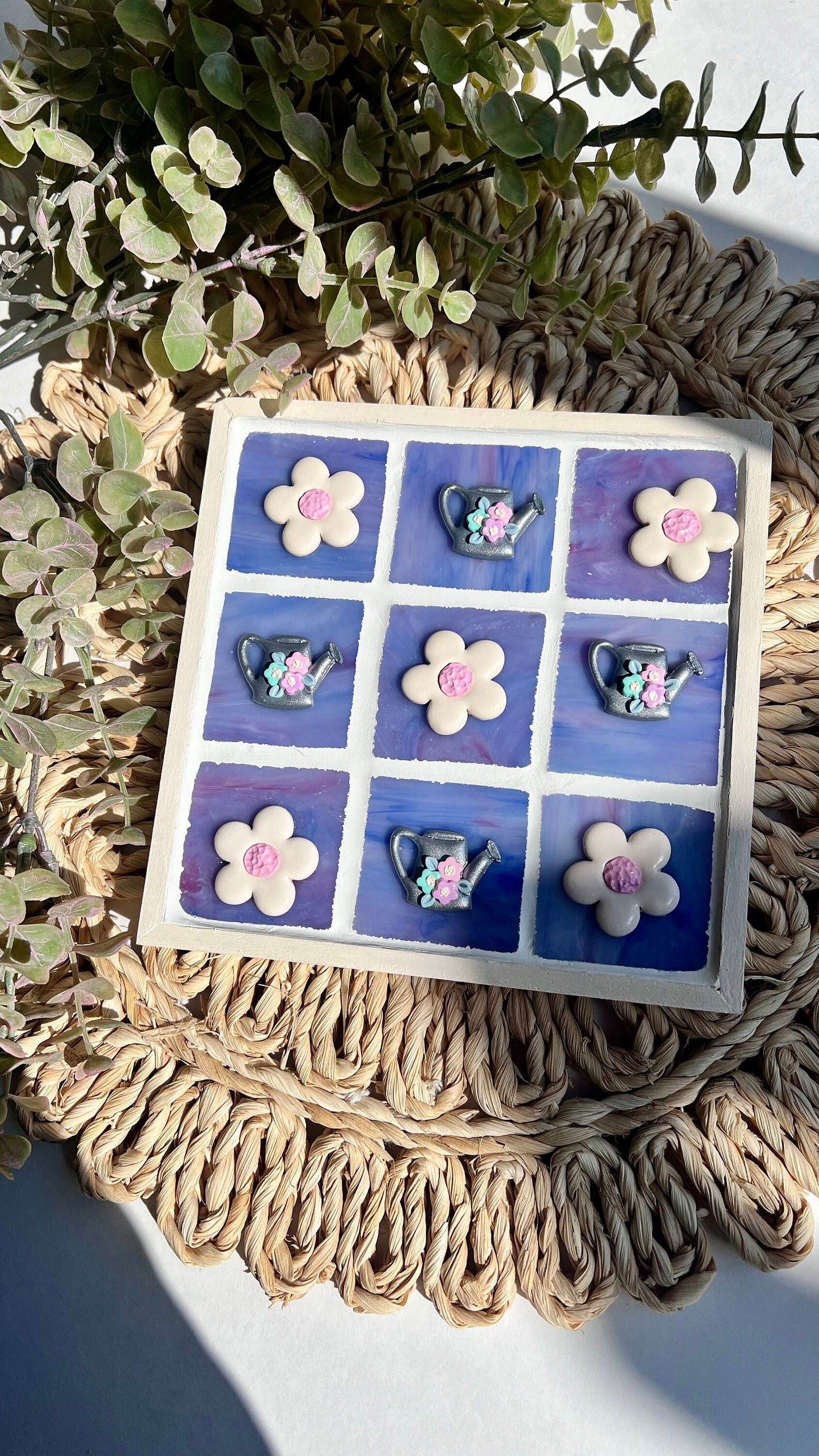 Stained glass tic tac toe board with watering can and daisy playing pieces