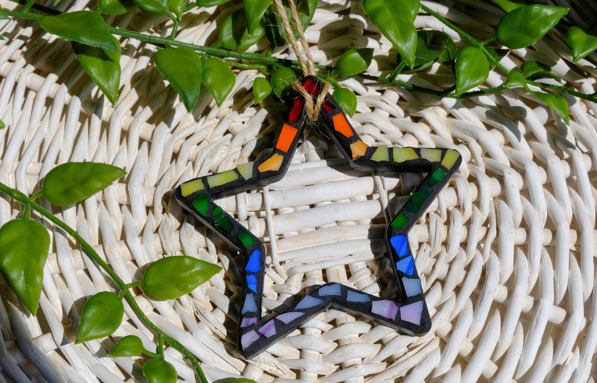 Rainbow Star stained glass mosaic ornament with black grout and a jute cord hanger